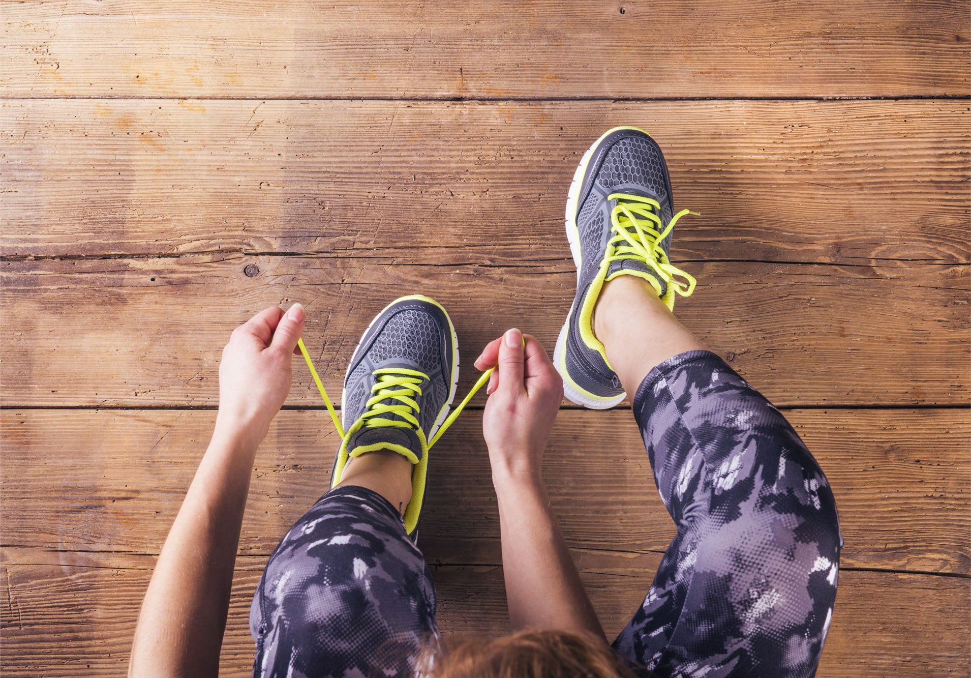 Woman lacing up running sneakers
