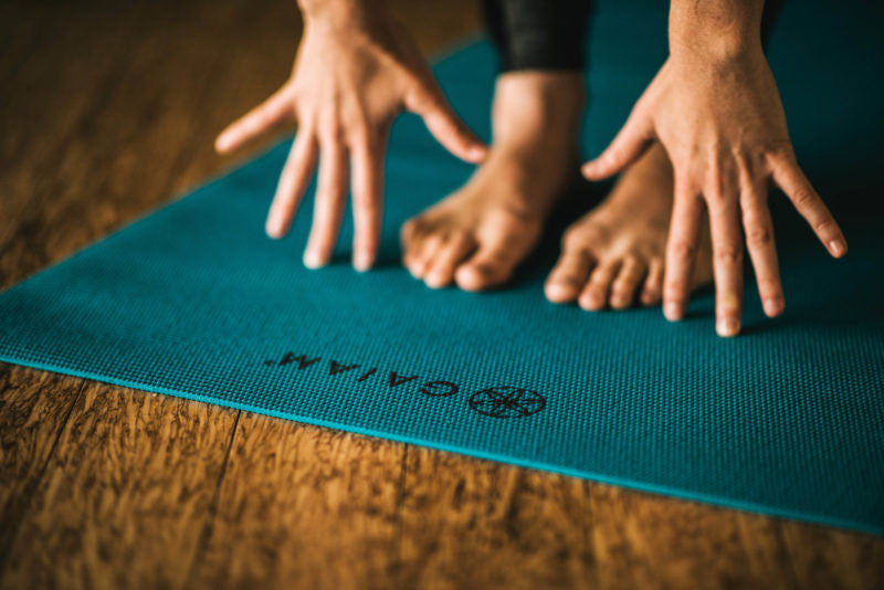 Hands and feet on a yoga mat