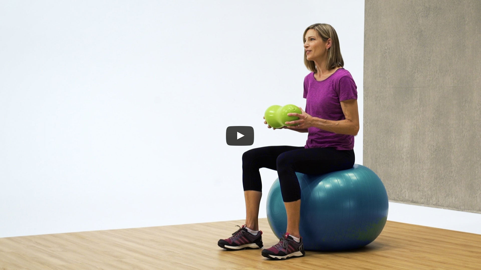 Woman sitting on an inflated balance ball