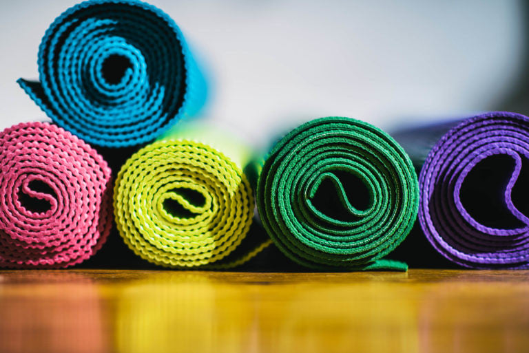 Colorful yoga mats rolled up